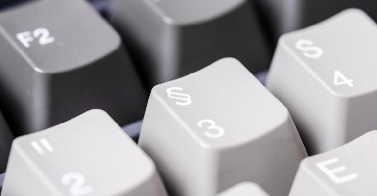 Close-up of grey computer keyboard with symbols.